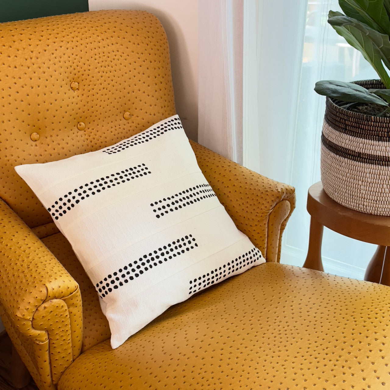 white sadza pillow on yellow sofa chair.