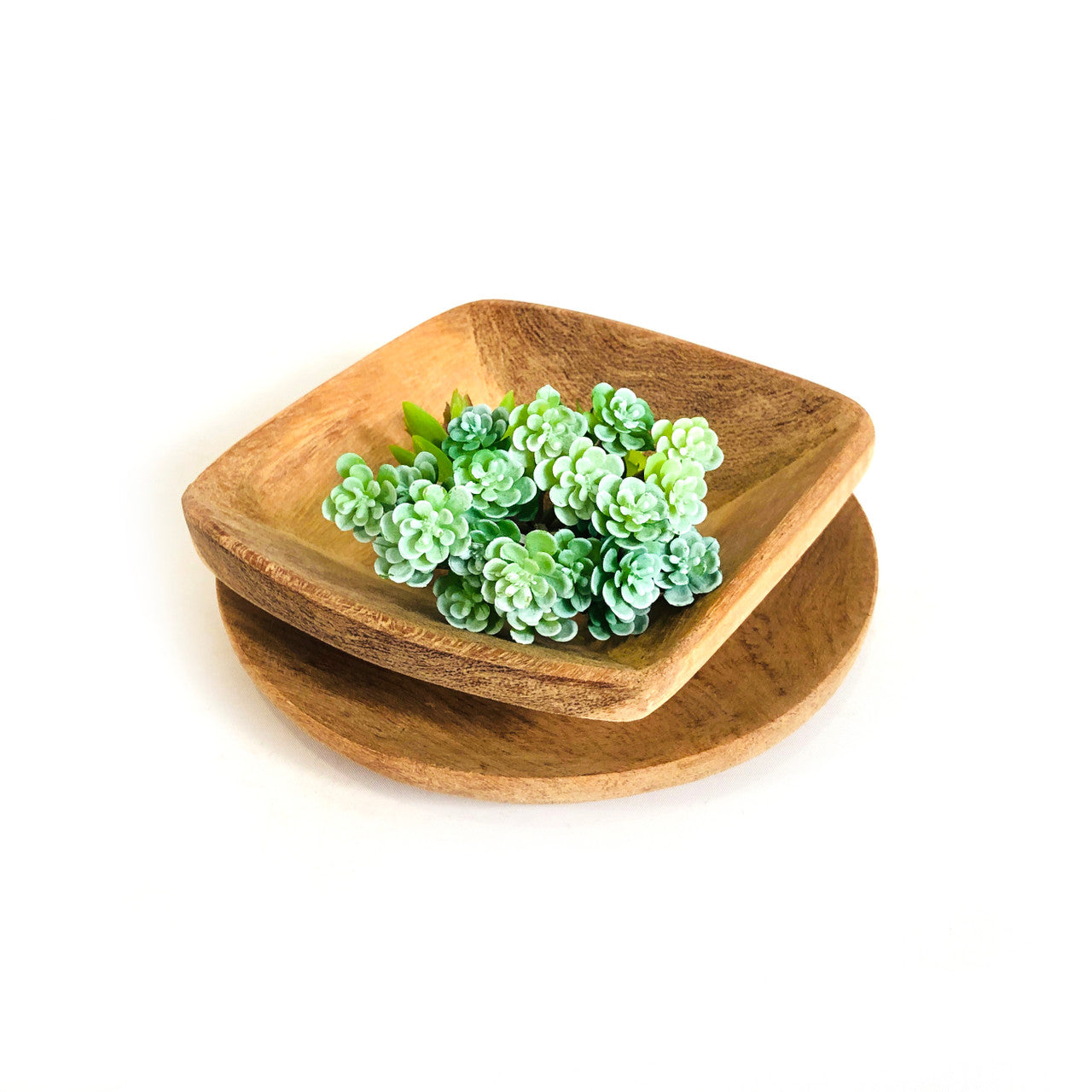 Square teak serving platter on top of the round teak platter
