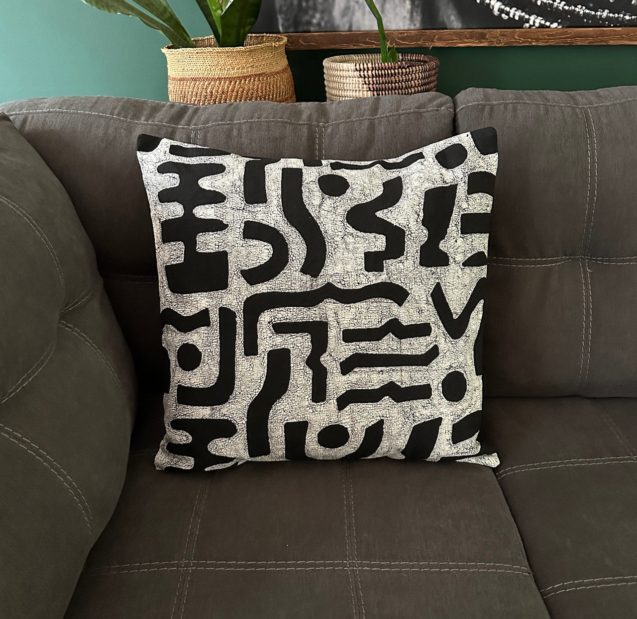 black and white pillow on a gray sofa