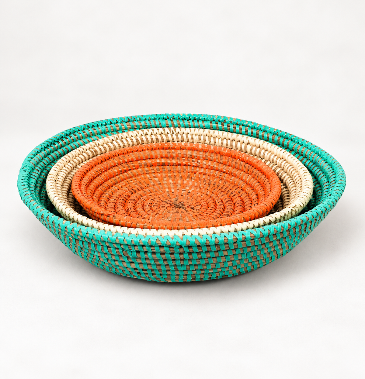 Set of 3 handwoven basket bowls in orange, turquoise and white from Senegal