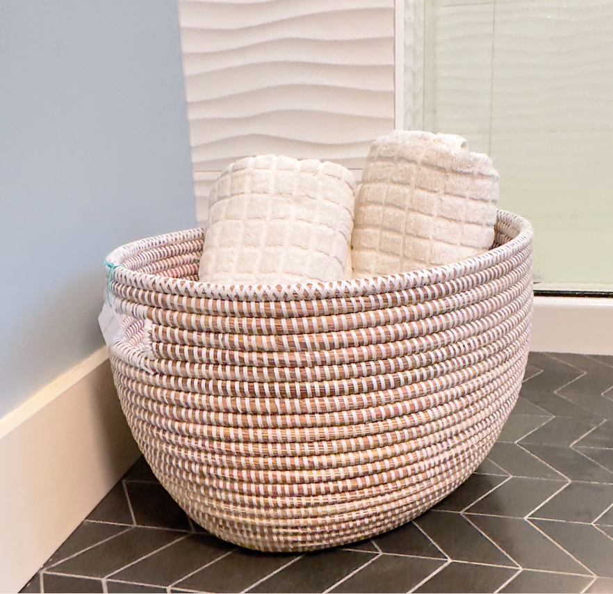 white basket perfect for towels in the bathroom
