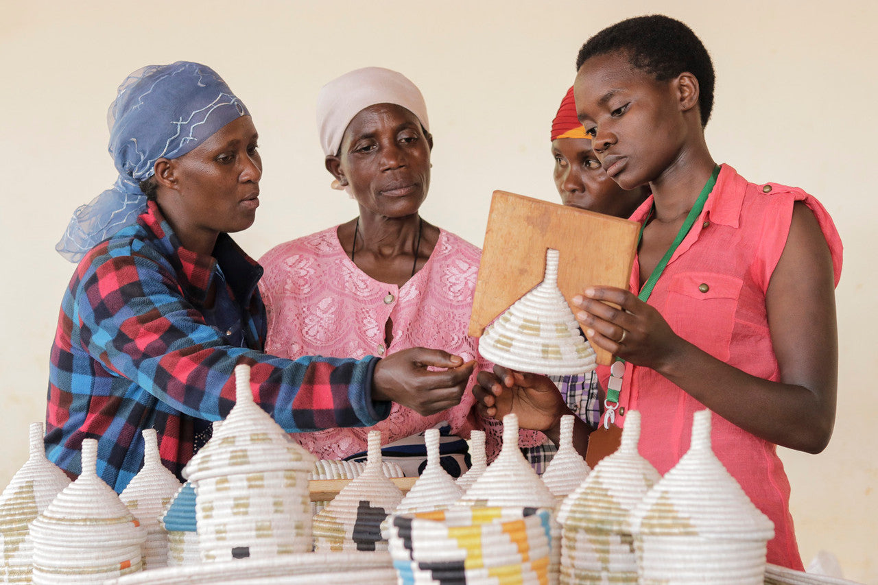women weavers learning to use a mold for weaving.