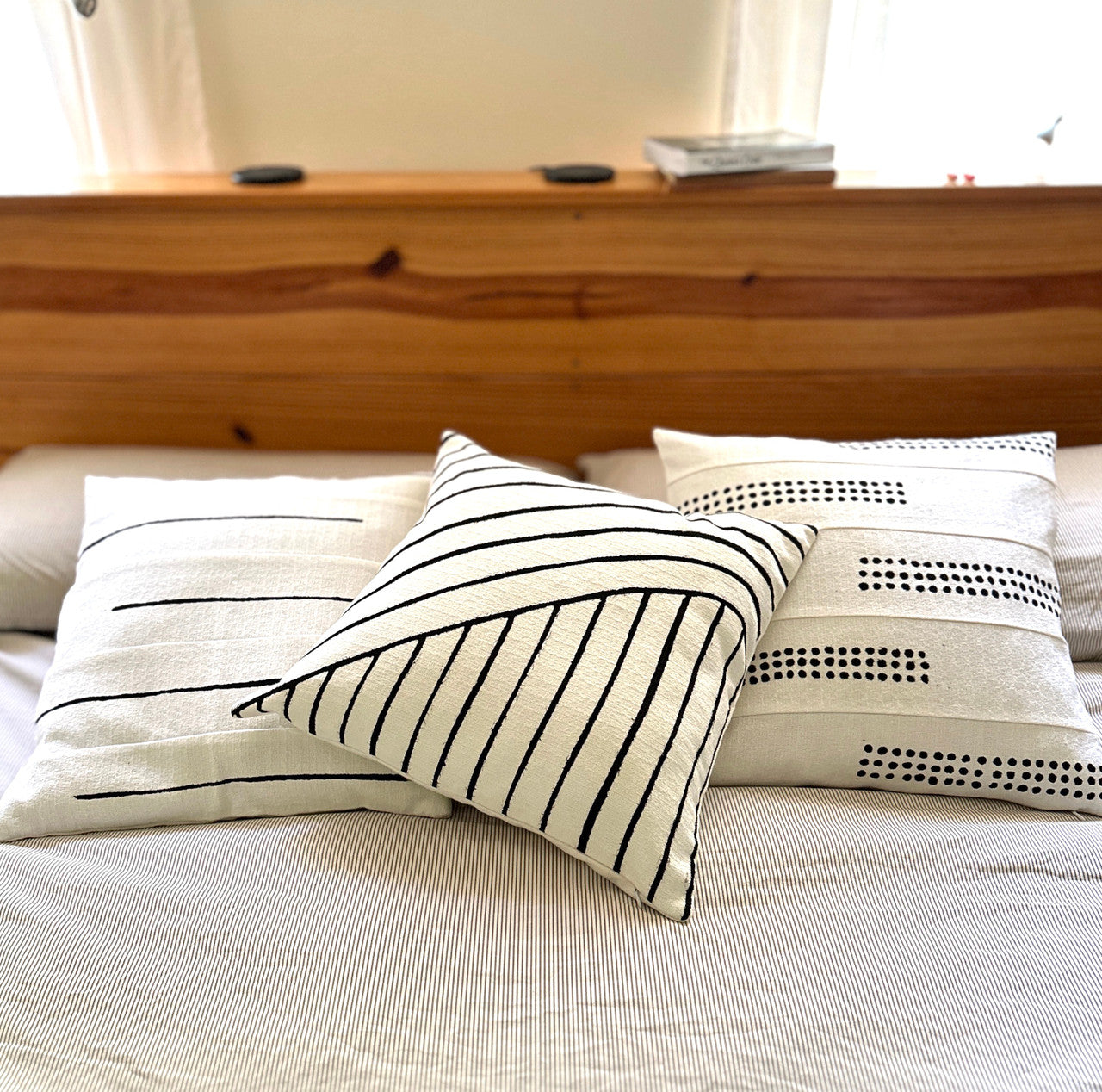 white boho pillows on bed