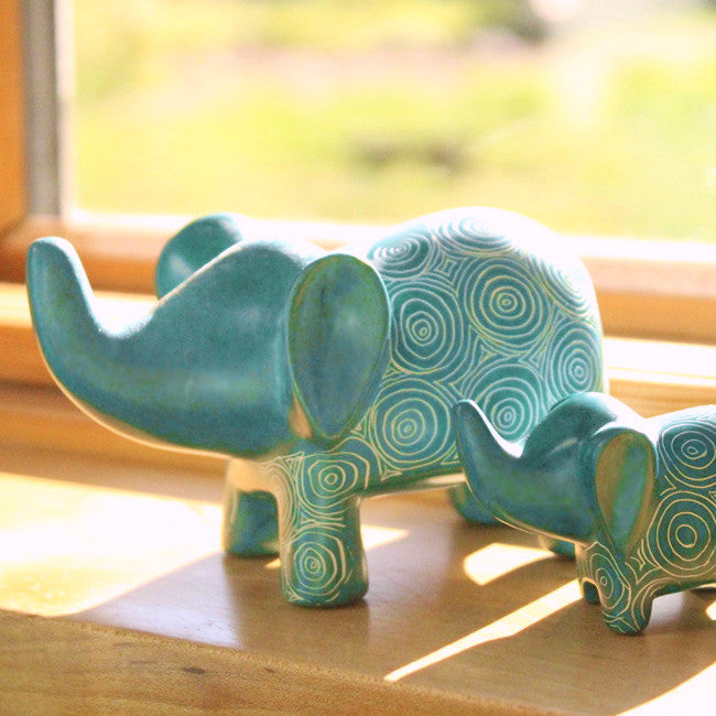 turquoise elephants on a windowsill