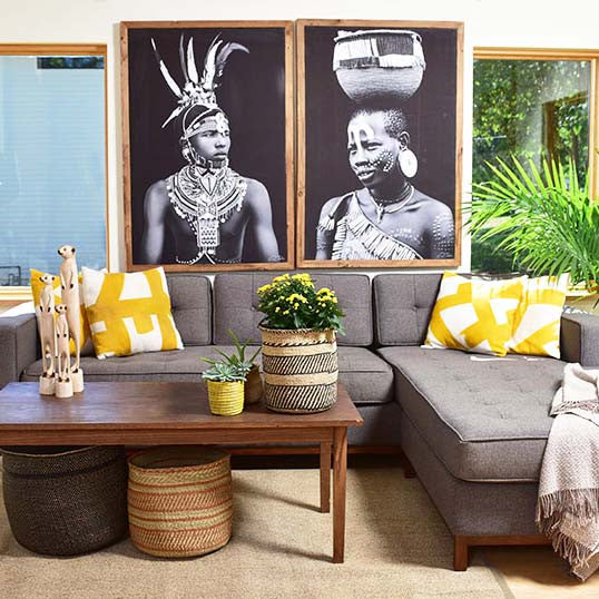 Ethiopian girl and Kenyan man photographs on canvas in a living room.