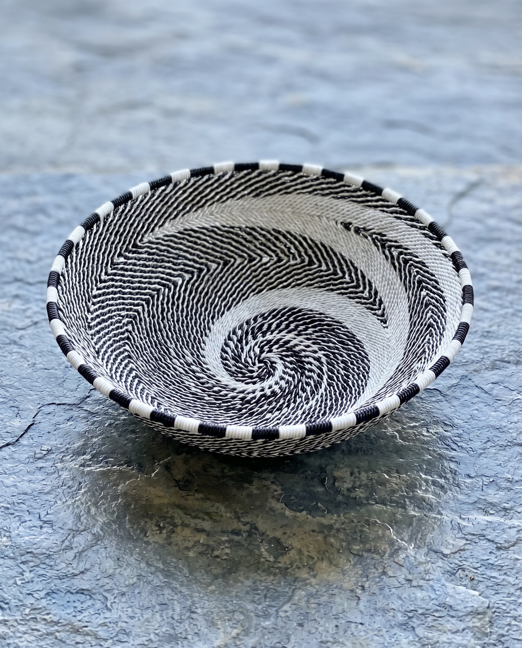 Zulu wire bowl in black and white on stone table