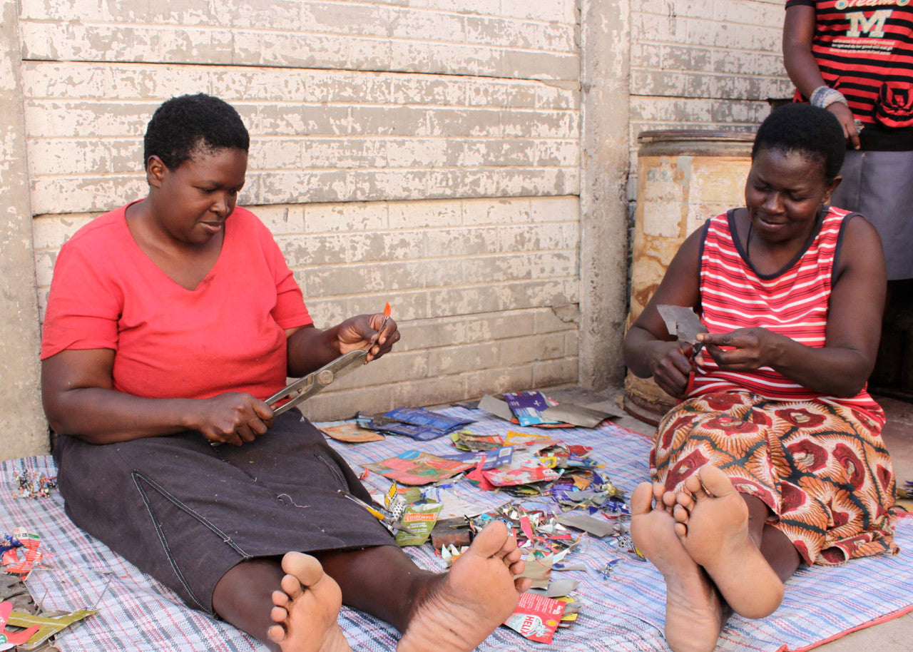 Women cutting tin with snips