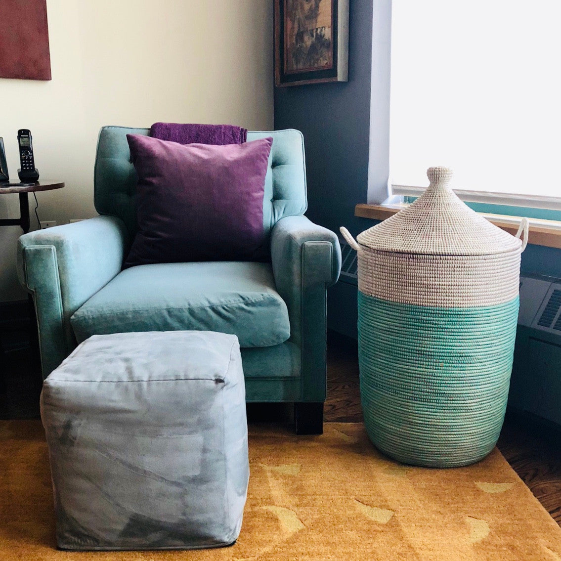 turquoise and white two-tone large basket in a living room
