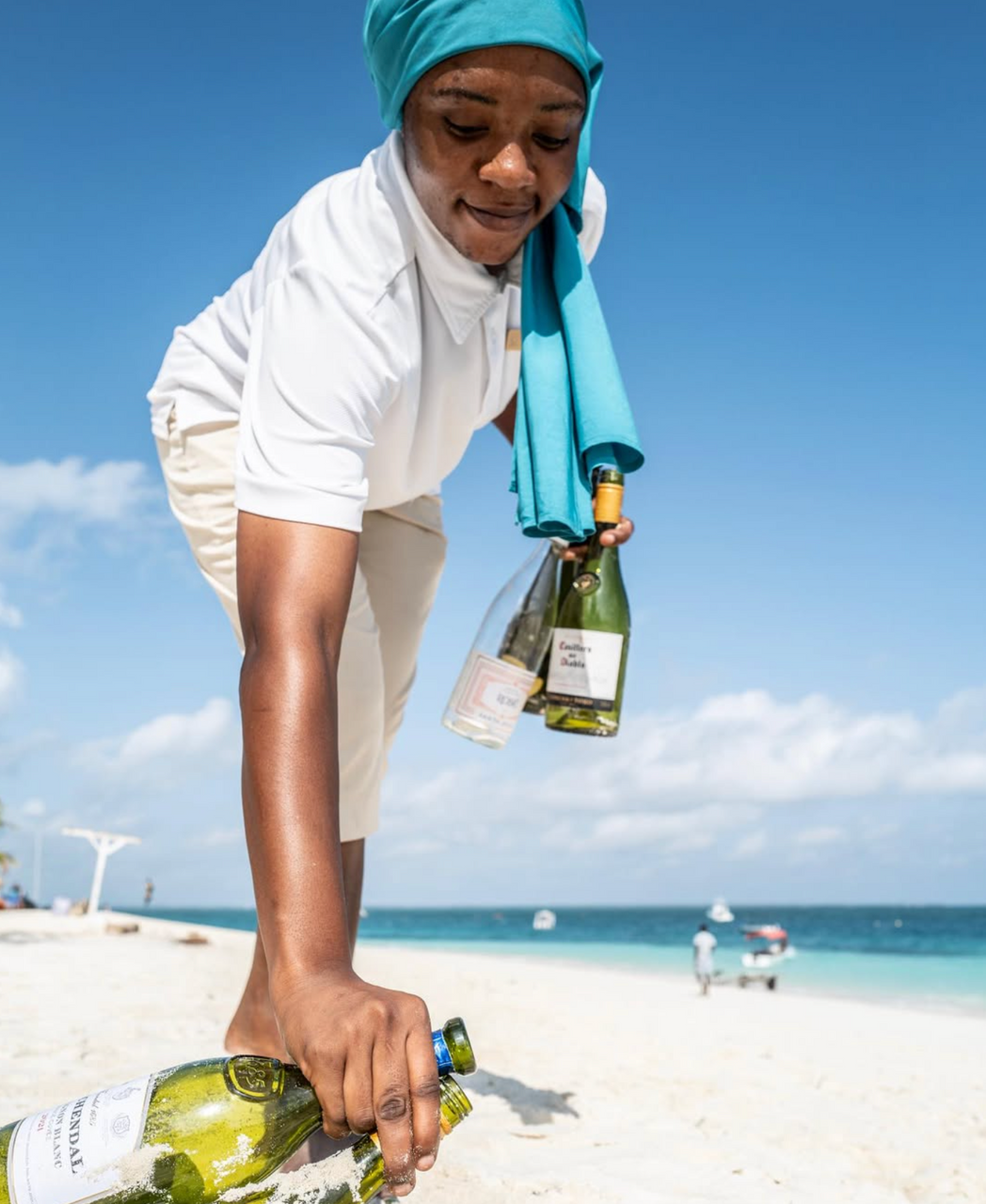 Chako collecting bottles on the beach