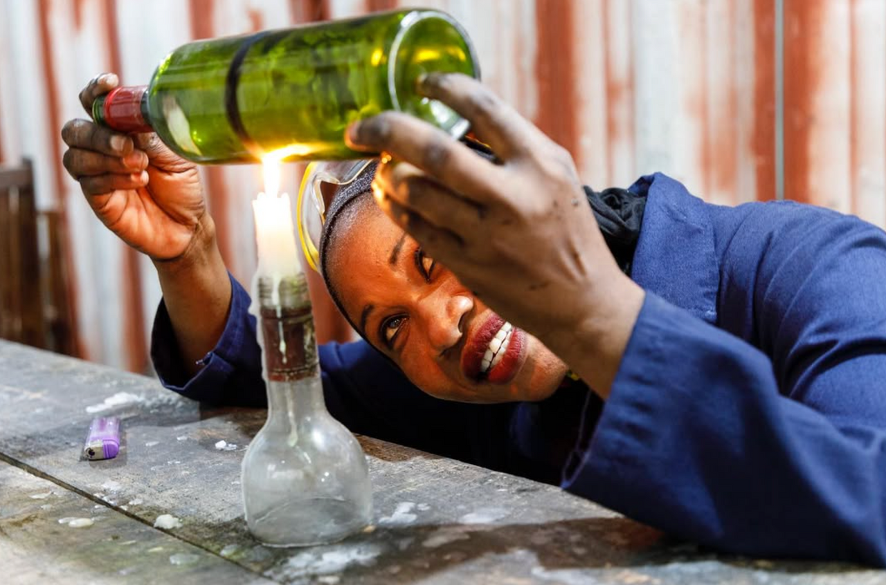 Chako woman employee cutting bottles with a candles