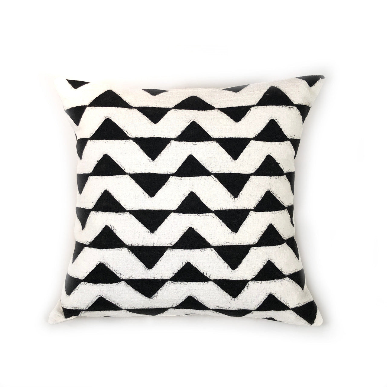white pillow with black triangles 